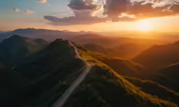 the sun sets in the distance over the mountains