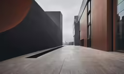 two buildings that have the same color, one with an oval on it