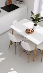 modern white and wood dining table surrounded by 4 chairs