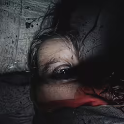 the reflection of a person in his eyes is seen through a partially opened umbrella