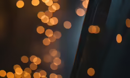 blurred gold lights are shining down on the wall