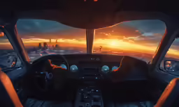 view from cockpit of sun setting in the sky over a city