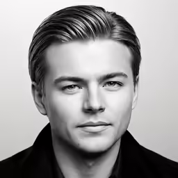 a man in black shirt looking at camera