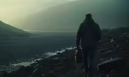 a person walking down a rocky mountain hill