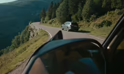 the view from a car shows two different vehicles driving on a road