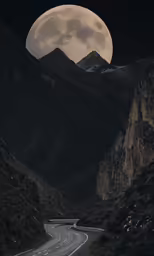 the full moon is shining brightly over a mountain side road