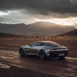 a sporty car driving on a dirt road