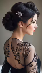 a woman wearing a black dress is looking off to the side