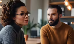 a man and woman looking at each other with a concerned look
