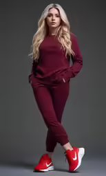 a blonde woman with long blond hair wearing a purple sweatshirt and maroon pants