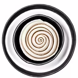 the dough is sliced into quarters in a black and white bowl