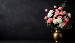 a vase with pink and white flowers in it