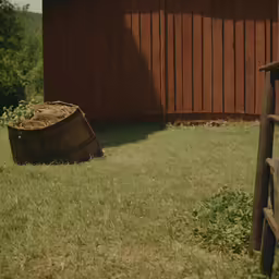 there is a wood barrel in the grass outside