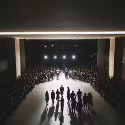 an open space where lots of people are sitting in