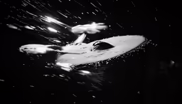 a black and white photo of a surfboard in the water
