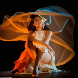a woman in white and orange is posing for the camera