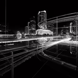 a black and white photo shows lights on buildings