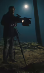 a man holding a light up in the sky