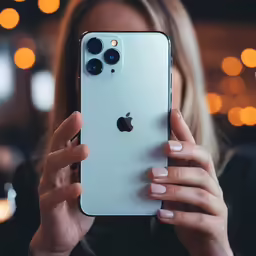 a close up of a person holding a phone