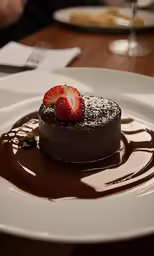 a slice of chocolate cake with a strawberry on top