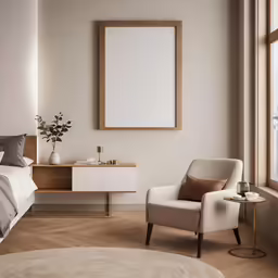 an empty chair sits next to a large white bed