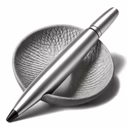 a silver ballpoint pen laying on top of a plate
