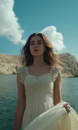 a girl in a white dress standing on the boat