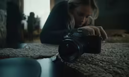 a woman is taking a photo while laying on the bed