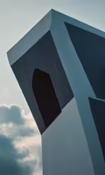 an abstract architectural photograph with clouds and blue sky