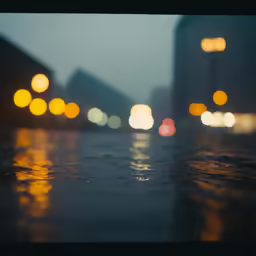 rain falls on the pavement in the city