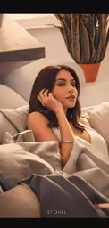 a woman with a bracelet sitting in bed