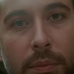 closeup shot of a man with beard wearing a suit