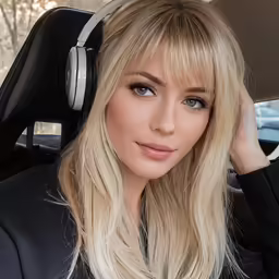blond woman wearing headphones in the car