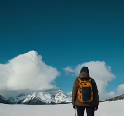 the woman is wearing skis standing in snow