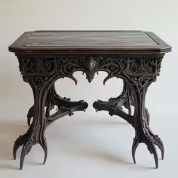 a black iron table with decorative details on it