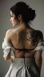 a woman with black ink on her back