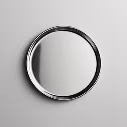 round mirror on wall with reflection of one of the walls,a metal circle that is against a wall