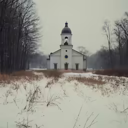 there is a very small white building in the middle of a snow covered field