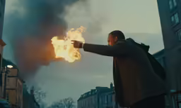 a man points at a blazing object in the air