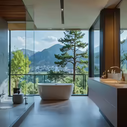 this bathroom features a huge window overlooking the mountains