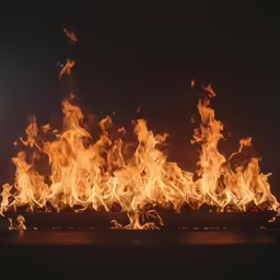 a close - up image of an open fire with flames and black background