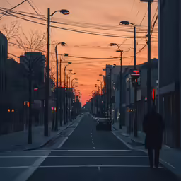 the man walks down the street during the sun set