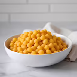 a white bowl filled with yellow food items