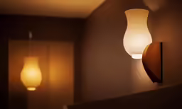 two lamps in a dimly lit room one on and one off