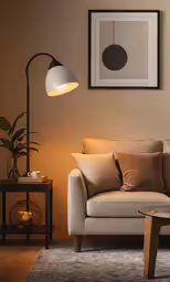 a couch with a beige linen and pillows, a coffee table and some lights