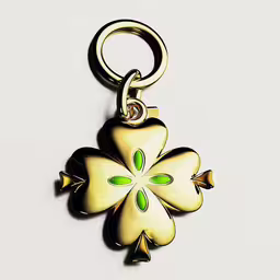 a yellow metal key chain with a flower shape on it,a keyring with a design is hanging from it