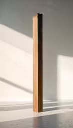 a wooden post standing in front of a wall