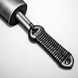 a hair dryer is being held up by a metal handle