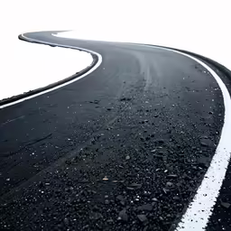 a curved road and white stripes on the side
