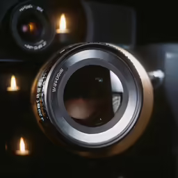a camera that is sitting next to candles